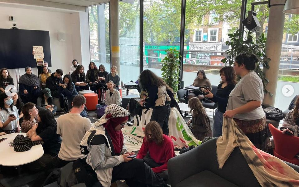 The students protesting in the library are demanding a meeting with managers