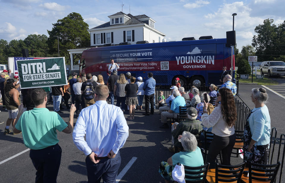 Virginia Gov. Glenn Youngkin, center, gestures during an early voting rally Thursday Sep. 21, 2023, in Petersburg, Va. Every Virginia legislative seat will be on the ballot in the November election, and both parties see a possible path to a majority. (AP Photo/Steve Helber)