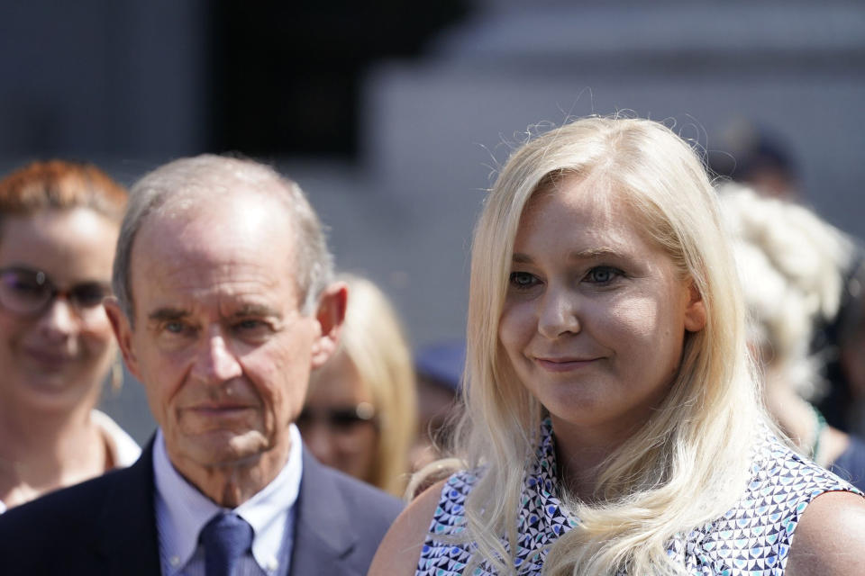 One of Jeffrey Epstein's alleged victims, Virginia Roberts Giuffre, right, speaks at a news conference following a hearing where Epstein's alleged victims made statements in Manhattan Federal Court on Aug. 27, 2019, in New York. (Barry Williams/New York Daily News/Tribune News Service via Getty Images)