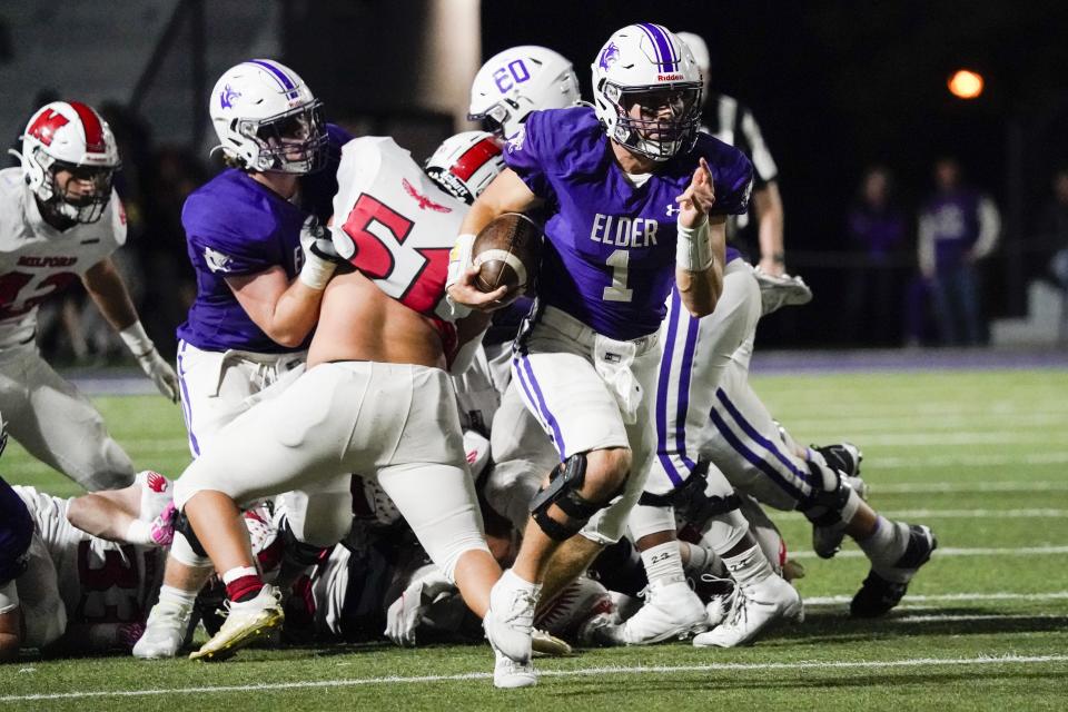 Elder quarterback Jack Reuter (1) runs the ball during the third quarter of a regional quarterfinal game against Milford at The Pit on Friday.