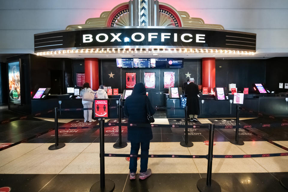 People buying tickets to the movies