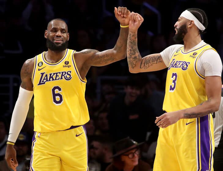 LOS ANGELES, CALIF. - NOV. 30, 2022. Lakers forward LeBron James, left, celebrates with teammate Anthony Davis after scoring a basket against the Blazers in the fourth quarter of the game at crypto.com Arena in Los Angeles on Wednesday night, Nov. 30, 2022. (Luis Sinco / Los Angeles Times)