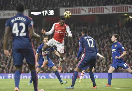 Arsenal's Danny Welbeck (C) heads the ball during their English Premier League soccer match against Manchester United at the Emirates Stadium in London November 22, 2014. REUTERS/Toby Melville