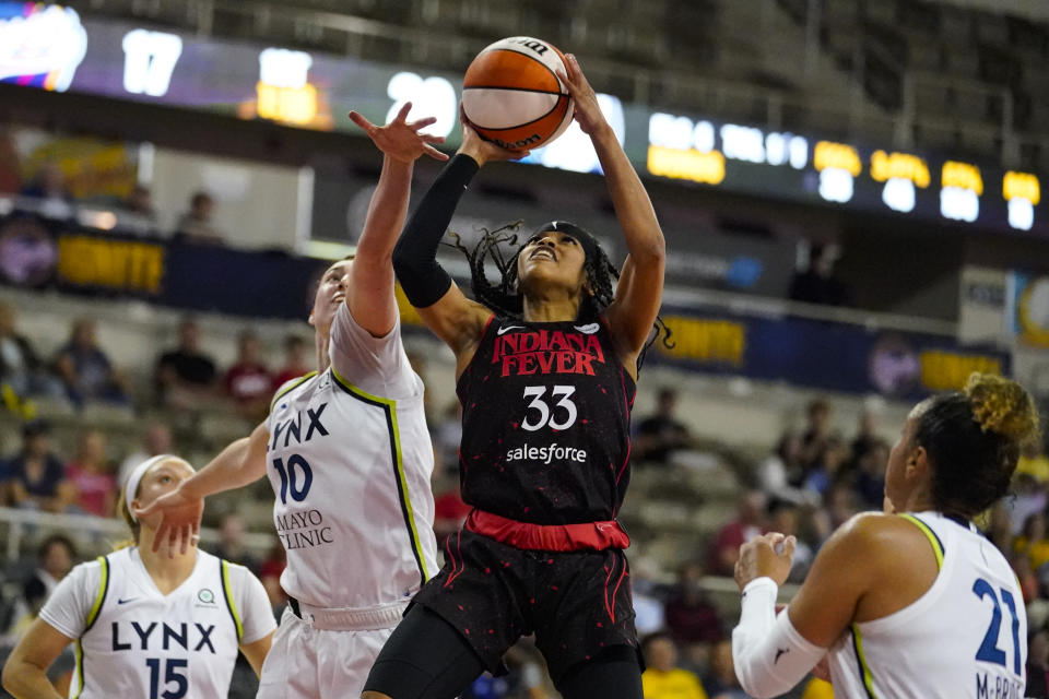 Indiana Fever guard Destanni Henderson (33) shoots in front of Minnesota Lynx forward Jessica Shepard (10) in the first half of a WNBA basketball game in Indianapolis, Friday, July 15, 2022. (AP Photo/Michael Conroy)