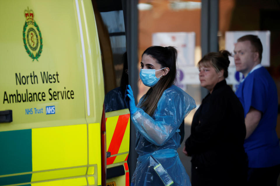 An NHS worker wearing a protective face mask opens an ambulance during the Clap for our Carers campaign in support of the NHS, following the outbreak of the coronavirus disease (COVID-19), Liverpool, Britain, May 14, 2020. REUTERS/Phil Noble
