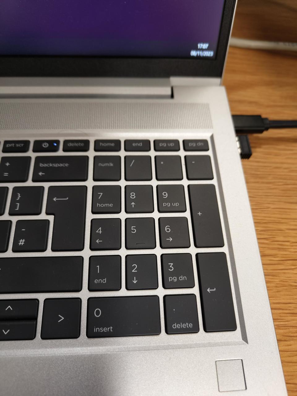 Close-up of a keyboard where gray dots appear between the keys but then disappear when you look directly at them