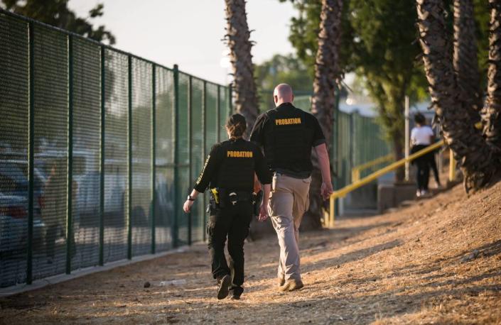 Law enforcement patrol around the stadium gate during the graduation ceremony at Grant Union High School on Thursday, June 1, 2023, in Sacramento’s Del Paso Heights neighborhood. The gates closed to graduate’s families and friends after it was announced that capacity had been reached.