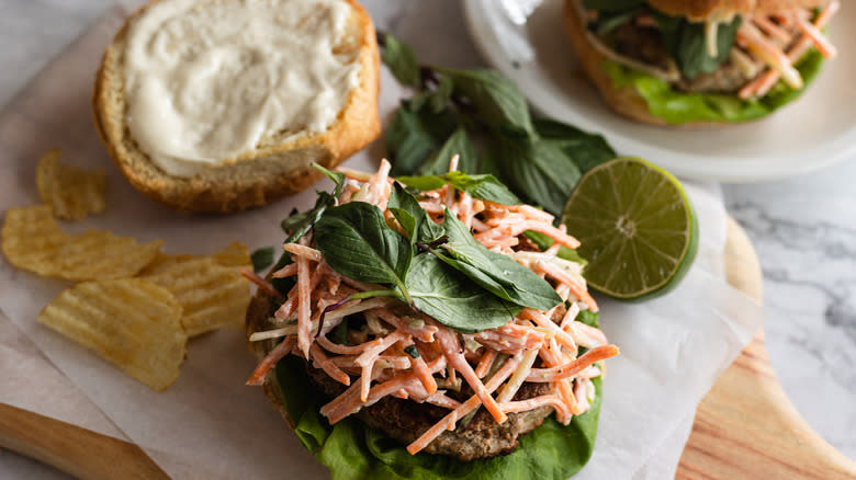 Open turkey burger with carrot slaw and Thai basil, second burger in back