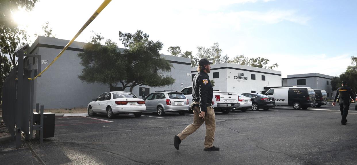 A Pima County constable walks into the crime scene at the Lind Commons apartment complex.