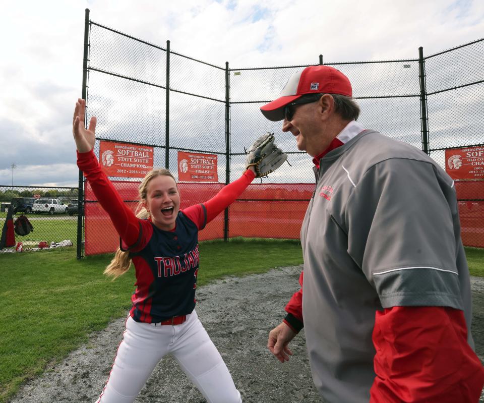 Bridgewater-Raynham head coach Mike Carrozza celebrates with player Emma Flaherty and teammates after he won his 400th career game versus Brockton on Wednesday, May 3, 2023. 