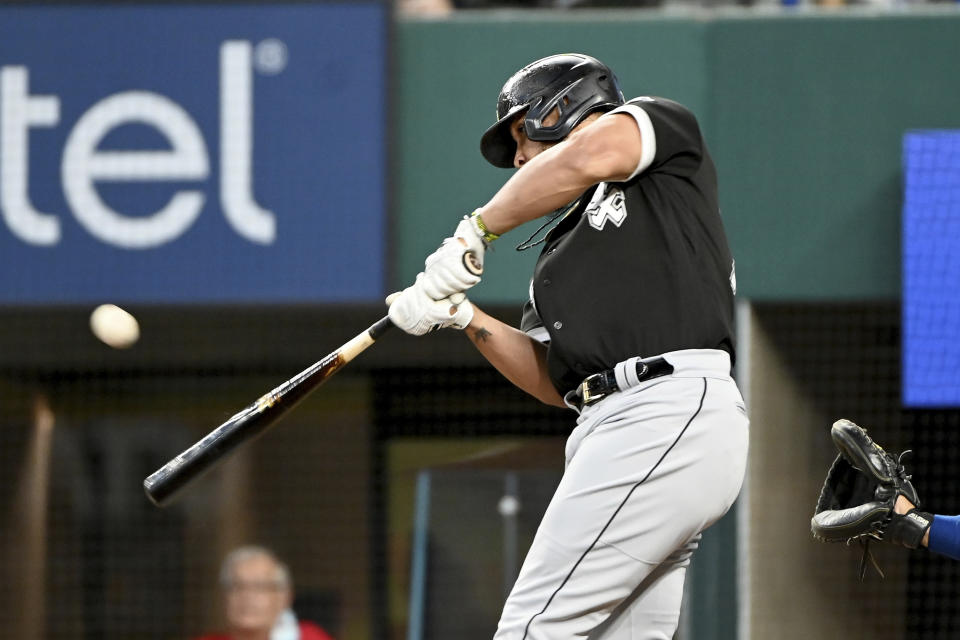 Chicago White Sox' Jose Abreu hits a two-run single in the fourth inning during a baseball game against the Texas Rangers in Arlington Texas, Sunday, Sept. 19, 2021. (AP Photo/Matt Strasen)