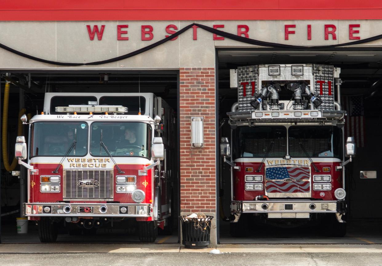 Black bunting is seen on Webster Fire Department headquarters Wednesday in honor of Firefighter Paul Cloutier, who died last week.