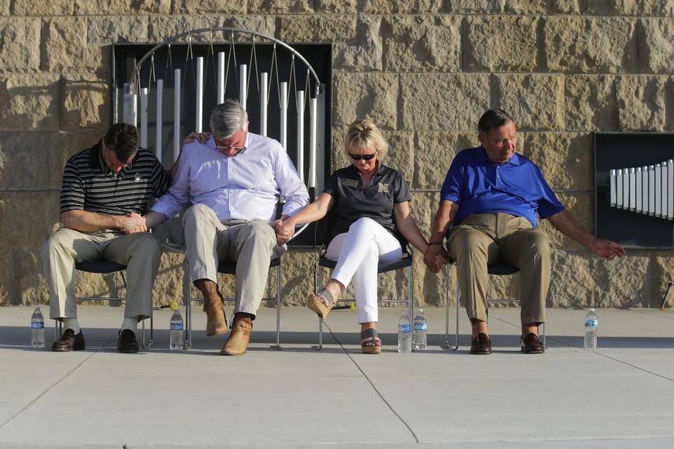 Senator Todd Young, Indiana Gov. Eric Holcomb, Noblesville Schools Superintendent Dr. Beth Niedermeyer, and Noblesville Mayor John Ditslear bow their heads in prayer during a May 2018 vigil held at Federal Hill Commons in Noblesville in response to a shooting at Noblesville West Middle School.