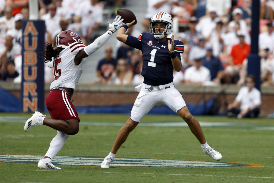 Auburn quarterback Payton Thorne (1) throws a pass as Massachusetts linebacker Derrieon Craig (15) defends during the first half of an NCAA college football game Saturday, Sept. 2, 2023, in Auburn, Ala. (AP Photo/Butch Dill)