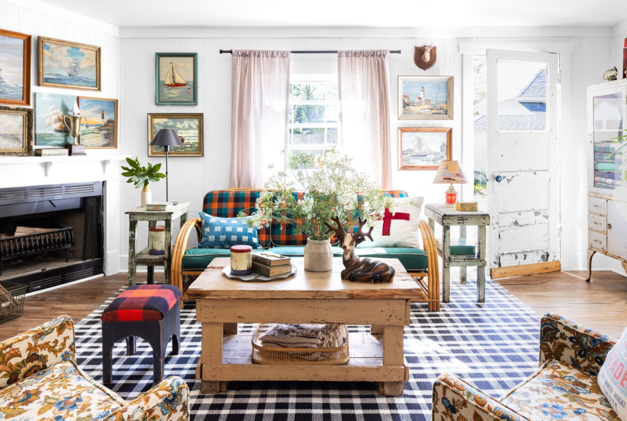 collected living room with a fireplace and gallery wall of vintage paint by numbers