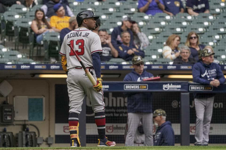 Atlanta Braves' Ronald Acuna Jr. walks back to the dugout after striking out during the eighth inning of a baseball game against the Milwaukee Brewers Sunday, May 16, 2021, in Milwaukee. (AP Photo/Morry Gash)