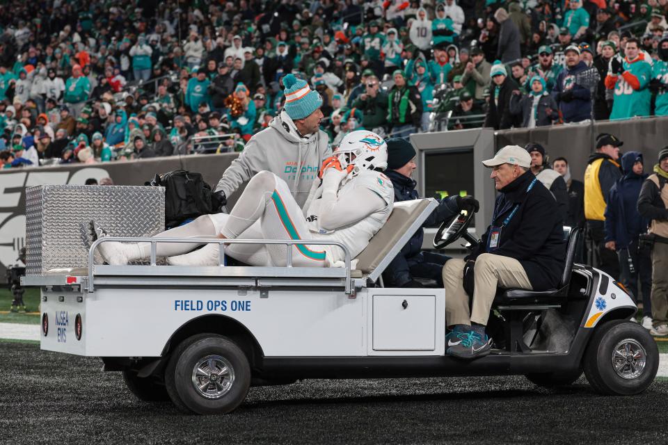 Nov 24, 2023; East Rutherford, New Jersey, USA; Miami Dolphins linebacker Jaelan Phillips (15) is driven off the field after an apparent injury during the second half against the New York Jets at MetLife Stadium. Mandatory Credit: Vincent Carchietta-USA TODAY Sports