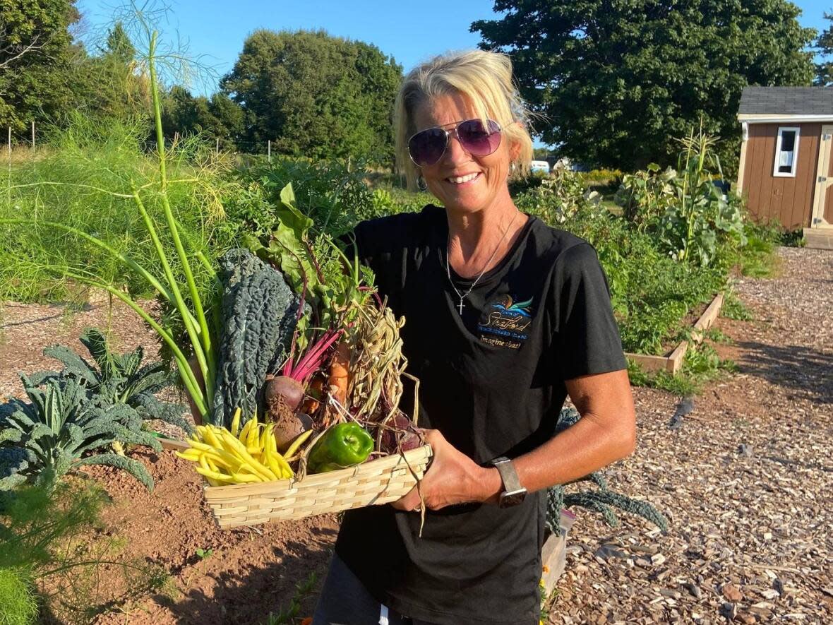 Avid home gardener and horticulturalist Heidi Wood with some of her garden's bounty. She's hoping to facilitate instructional garden seminars in the future.  (Joyce Wood - image credit)