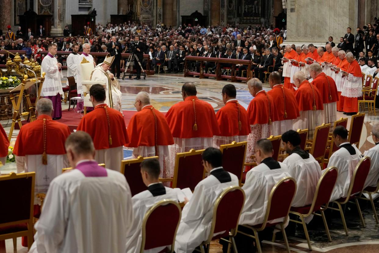 Pope Francis prays in front of new Cardinals during consistory inside St. Peter's Basilica on Saturday.