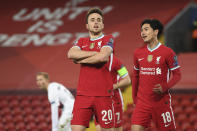 Liverpool's Diogo Jota, 20, celebrates scoring his side's first goal with Liverpool's Takumi Minamino, right, during the Champions League Group D soccer match between Liverpool and FC Midtjylland at Anfield stadium, in Liverpool, England, Tuesday, Oct. 27, 2020. (Michael Regan/Pool via AP)