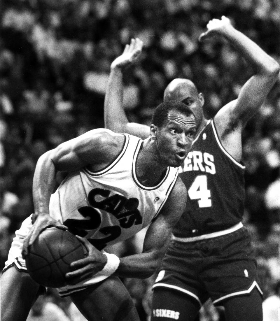 The Cleveland Cavaliers' Larry Nance drives to the basket against the Philadelphia 76ers' Charles Barkley at the Richfield Coliseum on May 1, 1990, in Richfield, Ohio.