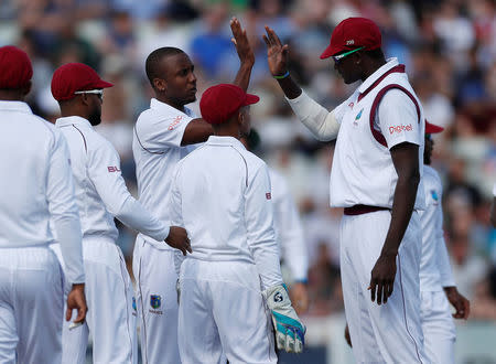 Cricket - England vs West Indies - First Test - Birmingham, Britain - August 17, 2017 West Indies' Jason Holder (R) and Miguel Cummins celebrate the wicket of England's Tom Westley Action Images via Reuters/Paul Childs