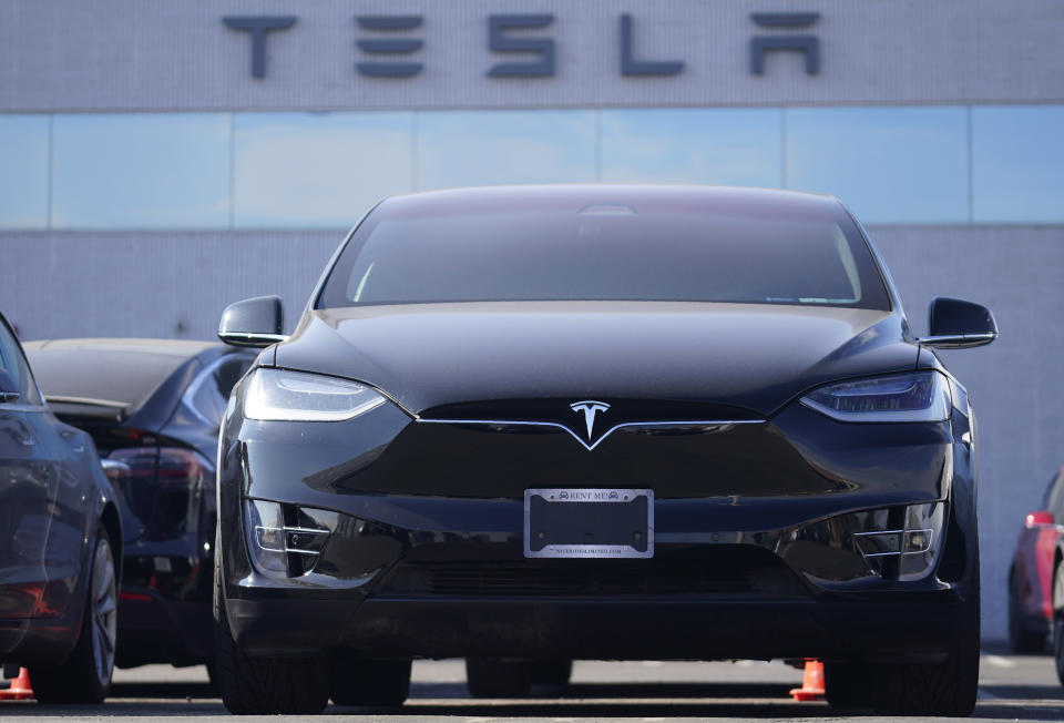 An unsold 2021 Model X sports-utility vehicle sits at a Tesla dealership Sunday, Jan. 24, 2021, in Littleton, Colo. Tesla reports earnings on Wednesday, Jan. 21.  (AP Photo/David Zalubowski)