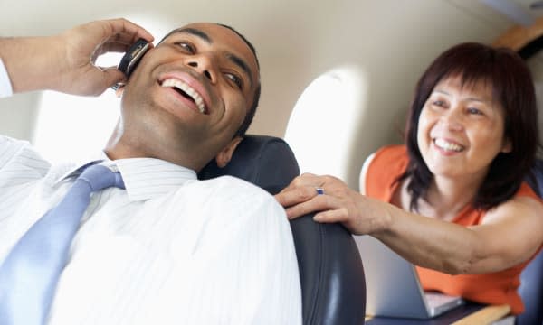 Multi-ethnic businesspeople on airplane