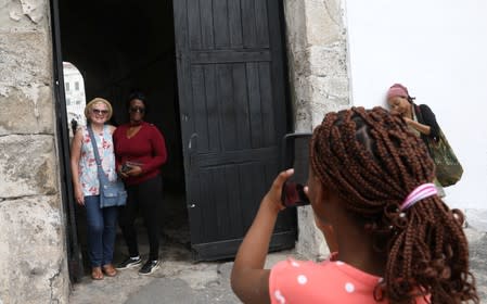 American tourist, Divine Koufahenou takes a picture of her Mother Afi and her friend Dawn Kravig at the 'Door of No Return' at the Cape Coast Slave Castle