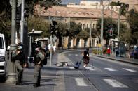 Israeli border police women stand by a main road in down town Jerusalem as Israel is set to tighten its second nationwide coronavirus disease (COVID-19) lockdown amid a rise in infections, later today, in Jerusalem