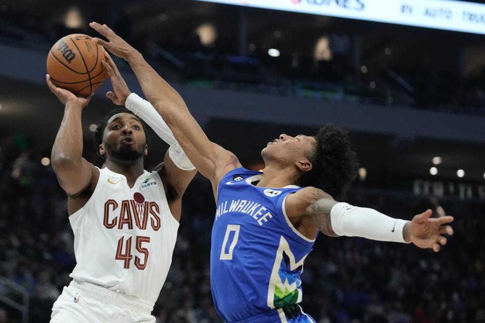 Cleveland Cavaliers' Donovan Mitchell shoots past Milwaukee Bucks' MarJon Beauchamp during the first half of an NBA basketball game Wednesday, Nov. 16, 2022, in Milwaukee. (AP Photo/Morry Gash)