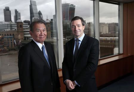 Nikkei Chairman Tsuneo Kita (L) and Financial Times Chief Executive Officer John Ridding pose for a photograph at the Financial Times headquarters in London, Britain November 30, 2015. REUTERS/Suzanne Plunkett
