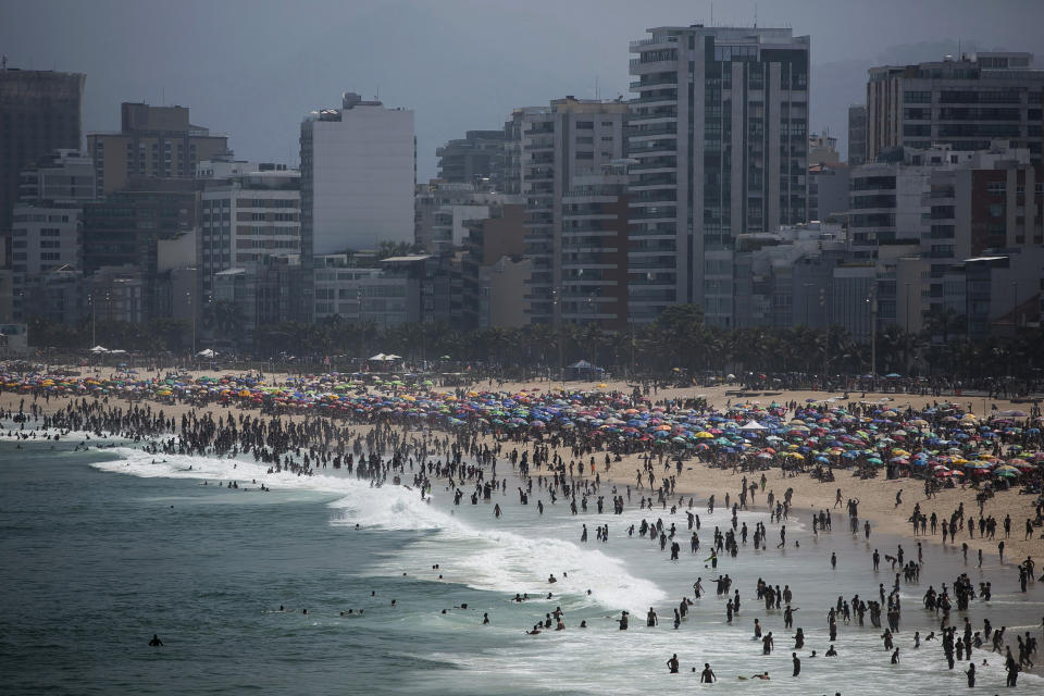 People enjoy the Ipanema beach amid the new coronavirus pandemic in Rio de Janeiro, Brazil, Sunday, Sept.6, 2020. Brazilians are packing the beaches and bars this weekend, taking advantage of a long holiday to indulge in normal life even as the COVID-19 pandemic rages on. (AP Photo/Bruna Prado)