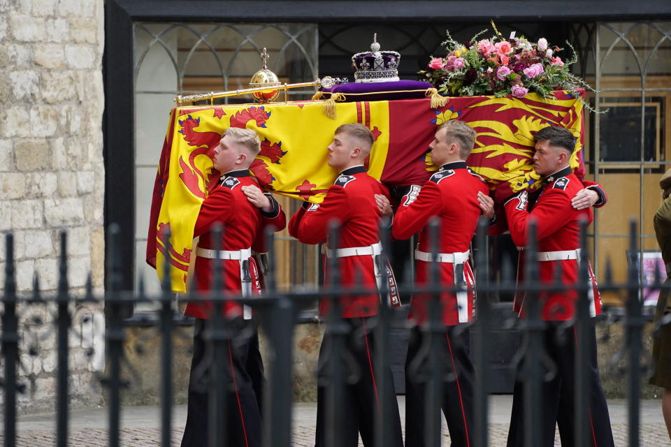 Pallbearers carry the coffin of Queen Elizabeth II, draped in the Royal Standard with the Imperial State Crown and the Sovereign's orb and sceptre, into her State Funeral at Westminster Abbey, in London on September 19, 2022. (Photo by James Manning / POOL / AFP) (Photo by JAMES MANNING/POOL/AFP via Getty Images)