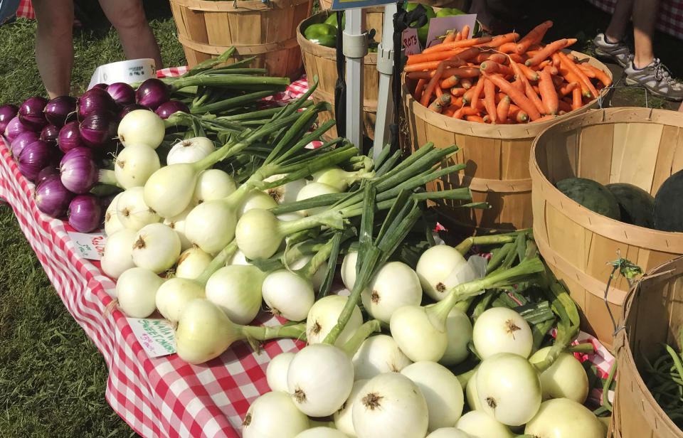 Various vegetables are displayed for sale at a farmer's market in Waitsfield, Vt., on Aug. 28, 2021. Signing up for a Community-Supported Agriculture program means getting a box of produce from local farms every week or two. It's a great way to take advantage of summer's bounty, discover new fruits and vegetables, and support the folks who grow food in your area. (AP Photo/Carolyn Lessard)