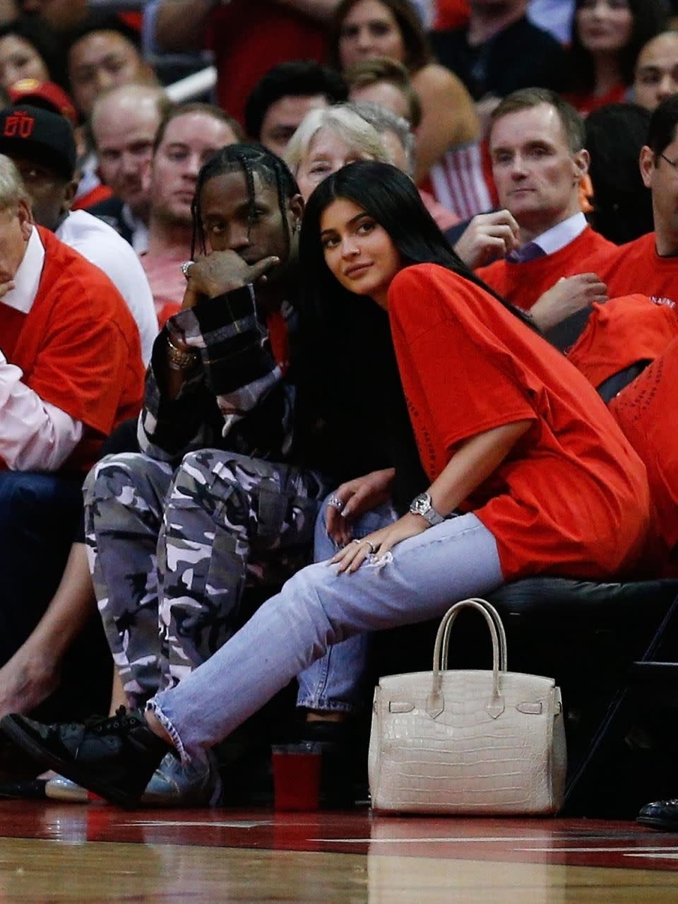 The 20-year-old is said to be expecting her first child with Travis Scott. The pair have been dating since April. Here they are pictured together at a basket ball game together earlier this year. Source: Getty