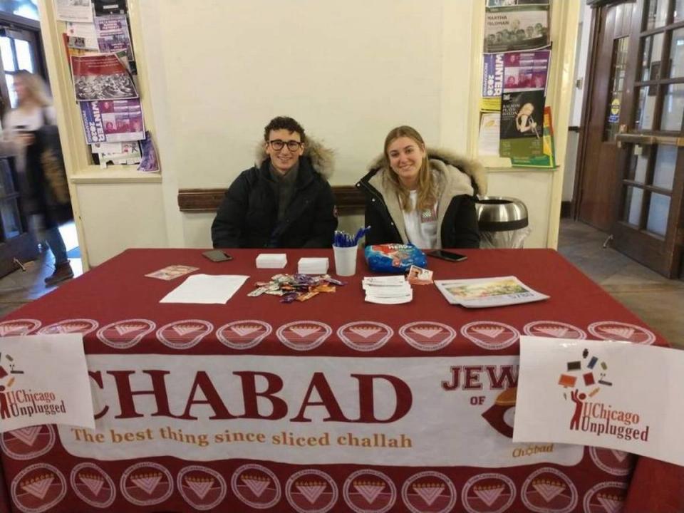 Ilan Naibryf with friend Isabel Wolfson manning a table for the Chabad.