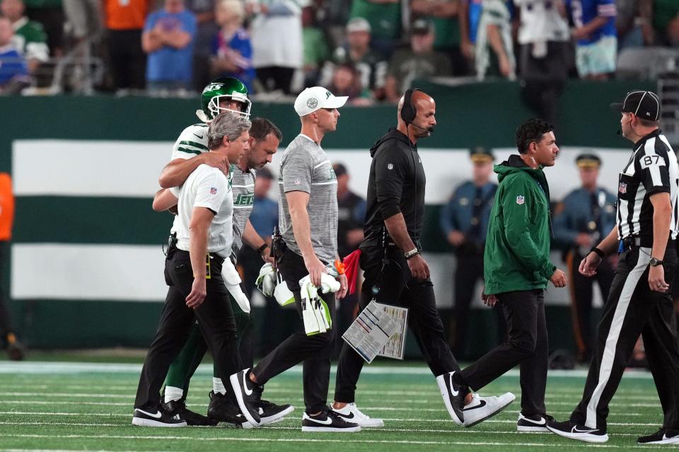 New York Jets quarterback Aaron Rodgers (8) is helped off the field after being sacked during the first half of the home opener at MetLife Stadium on Monday, Sept. 11, 2023, in East Rutherford.