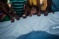 <p>A Nigerian woman aboard a partially punctured rubber boat reacts during a rescue operation on the Mediterranean sea, about 19 miles north of Az Zawiyah, Libya, on Thursday, July 21, 2016. Over the past weeks, vessels from NGOs, several nations’ military fleets and passing cargo ships have all rescued migrants from unseaworthy boats launched from Libya’s shores. (AP Photo/Santi Palacios) </p>