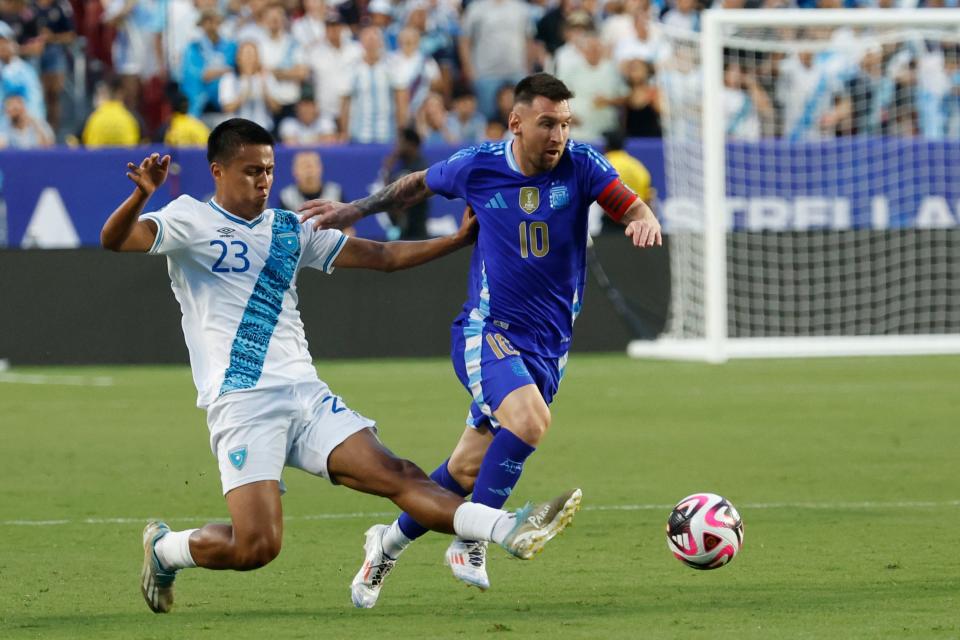 Argentina forward Lionel Messi dribbles the ball in the first half against Guatemala.