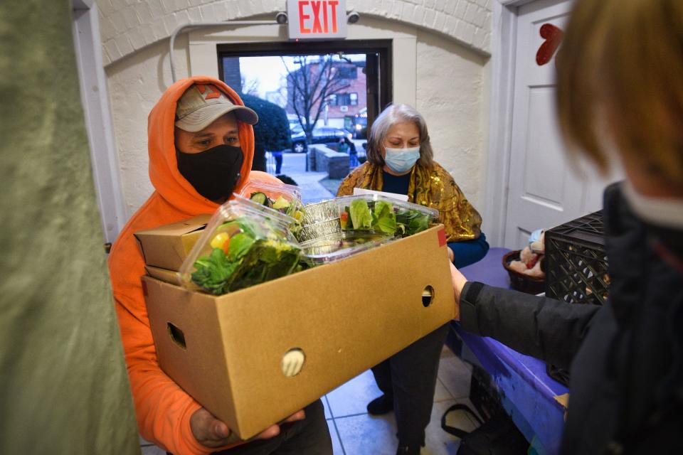 Mazro Branco of Fairview receives a box of the first delivery of meals from a volunteer that are provided under a $1M NJEDA grant to HealthBarn Foundation, at the Franciscan Community Development Center in Fairview on 03/08/21.