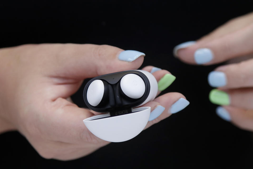 In this Tuesday, Sept. 24, 2019, photo Isabelle Olsson, head of color & design for Nest, shows the Pixel buds in a case at Google in Mountain View, Calif. (AP Photo/Jeff Chiu)