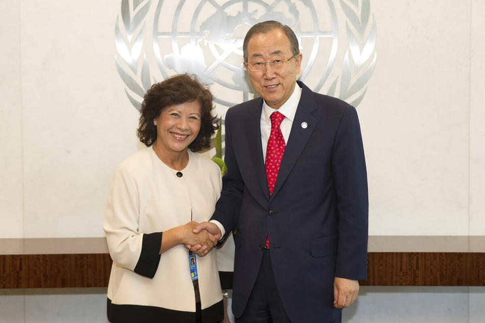 In this photo released by U.N. Photo, then U.N. Secretary-General Ban Ki-moon, right, poses with Noeleen Heyzer, then special adviser of the Secretary-General for Timor-Leste, for a photo at the U.N. headquarters on Sept. 12, 2014. Secretary-General Antonio Guterres on Monday, Oct. 25, 2021 announced the appointment of former U.N. undersecretary-general Heyzer of Singapore as the new U.N. special envoy for conflict-torn Myanmar. (U.N. Photo via AP)