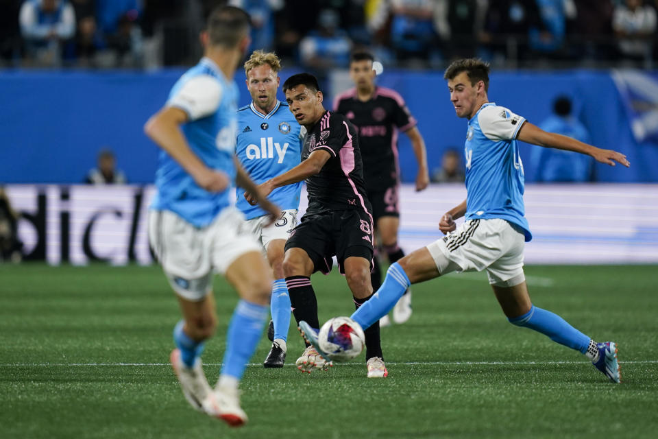 Inter Miami midfielder Diego Gómez (8) passes the ball under pressure from Charlotte FC midfielder Andrew Privett, right, during the second half of an MLS soccer match, Saturday, Oct. 21, 2023, in Charlotte, N.C. (AP Photo/Erik Verduzco)