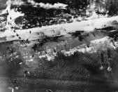 Men and assault vehicles storm the beach as Allied landing crafts reach their destination during the initial Normandy landing operations in France on June 6, 1944. (Photo: AP)