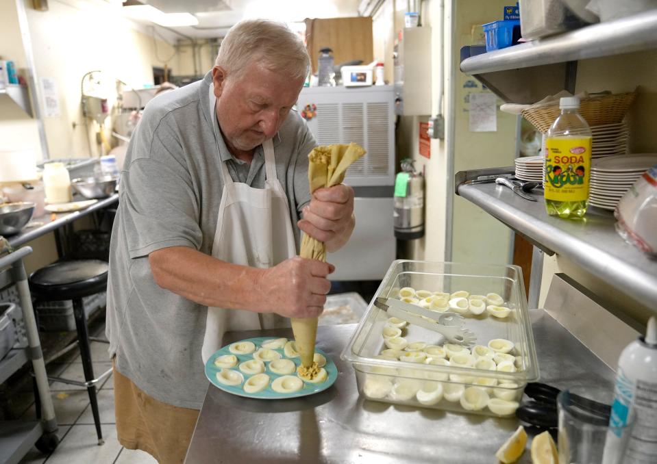 Polonez founder George Burzynski makes deviled eggs by the dozens for one of the Polish restaurant's final brunches.