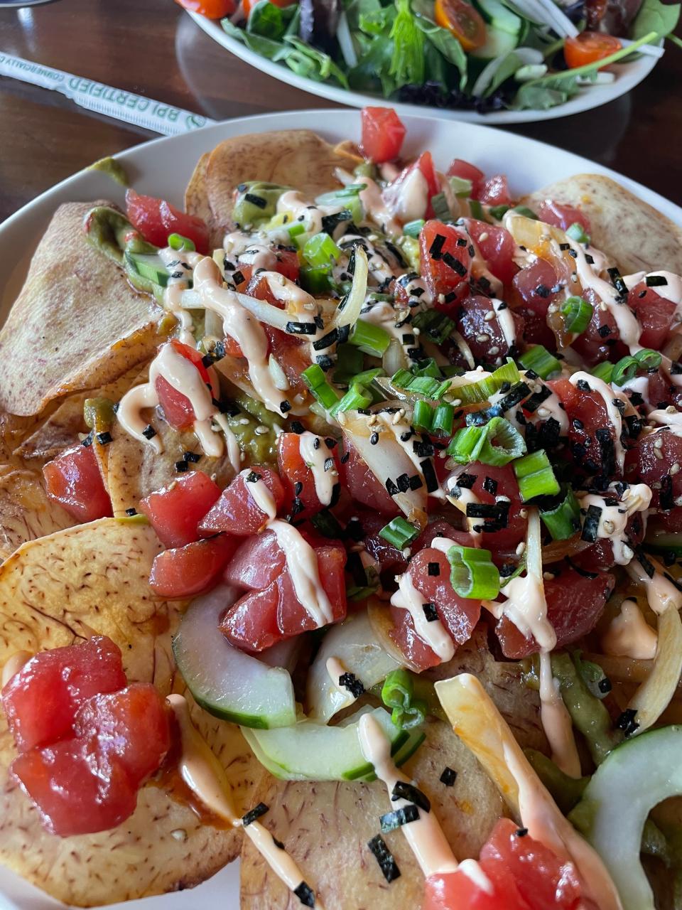 Instead of tortilla chips, the ahi poke nachos at Pounders use hand-cut taro chips, which is a root vegetable that's a staple in Hawaiian cuisine.