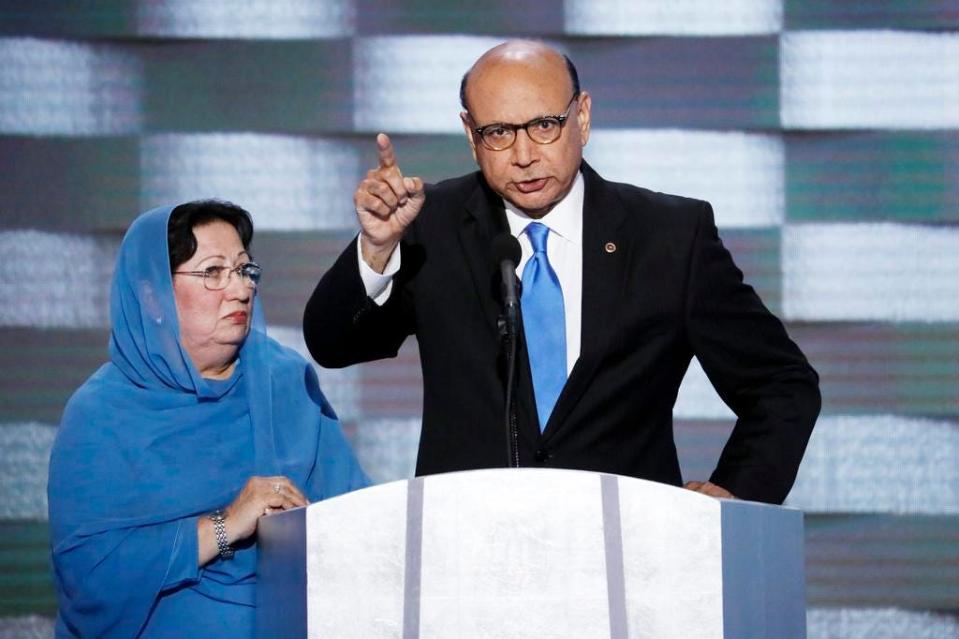 FILE- In this July 28, 2016, file photo, Khizr Khan, father of fallen U.S. Army Capt. Humayun S. M. Khan, accompanied by his wife Ghazala speaks at the Democratic National Convention in Philadelphia. President Donald Trump signed into law a bill naming a Virginia post office for Humayun Khan, whose father criticized the then-candidate in a 2016 Democratic National Convention speech. (AP Photo/J. Scott Applewhite, File)