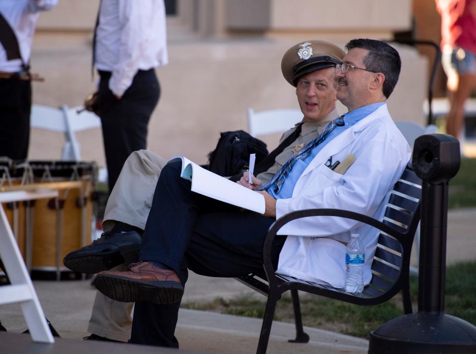 Cast members that portray Barney Fife, left, and Floyd Lawson — Rik Roberts and Allan Newsome respectively — relax between scene takes. The production crew of the movie “Mayberry Man” were recording outside of the Hendricks County Courthouse, Saturday, Sept. 5, 2020, in Danville, Ind.
