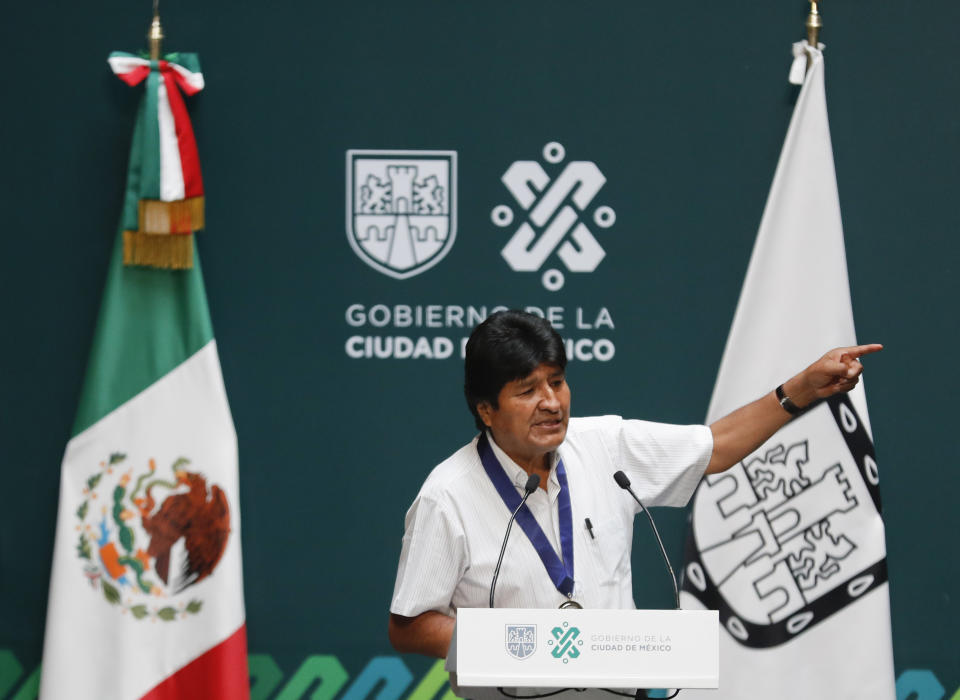 Former Bolivian President Evo Morales delivers his address after he was decorated with a distinguished citizen medal at City Hall in Mexico City, Wednesday, Nov. 13, 2019. Mexico granted asylum to Morales, who resigned on Nov. 10 under mounting pressure from the military and the public after his re-election victory triggered weeks of fraud allegations and deadly protests. (AP Photo/Eduardo Verdugo)